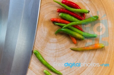 Chili And Knife On Wood Stock Photo