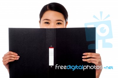 Chinese Woman Hiding Face With Business File Stock Photo