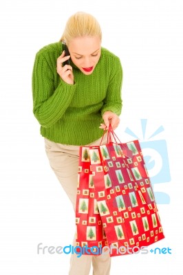 Christmas Shopper On Mobile Phone Stock Photo