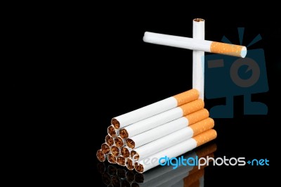 Cigarettes And Cross Stock Photo