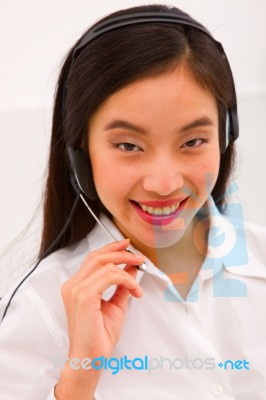 Close-up Of A Smiling Young Woman With Headset Stock Photo
