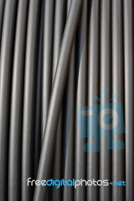 Close-up Of Black Electricity Cable Verticla On A Spool Stock Photo