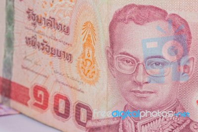 Close Up Of Thailand Currency, Thai Baht With The Images Of Thailand King. Denomination Of 100 Bahts Stock Photo