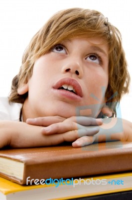 Close View Of Boy With Books And Looking Up Stock Photo