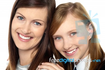 Closeup Of Mom And Daughter Flashing A Smile Stock Photo