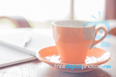 Closeup Orange Coffee Cup In Coffee Shop Stock Photo