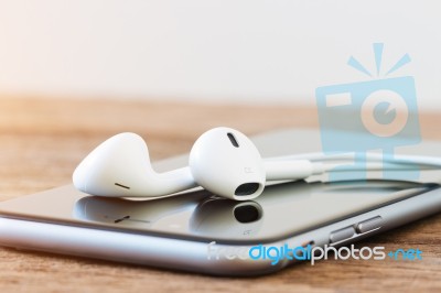 Closeup Phone And Headphone Device On Table Stock Photo