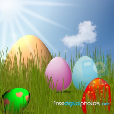 Colorful Easter Eggs Sitting On Grass Field With Blue Sky Background Stock Image