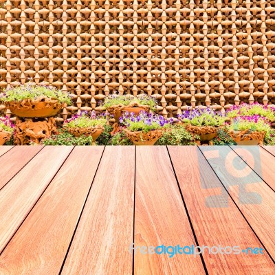Colorful Flowers With Decorative Wall Of Pottery Pots And Plank Stock Photo
