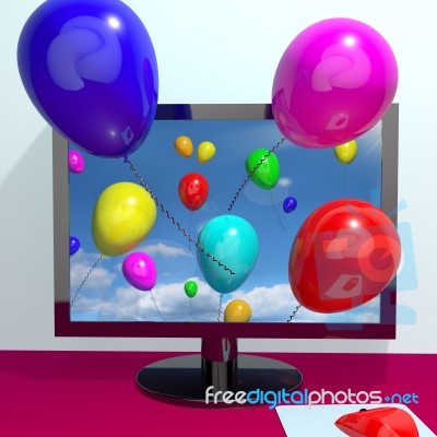 Computer with flying balloons Stock Image