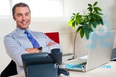 Confident Businessman At His Workstation Stock Photo
