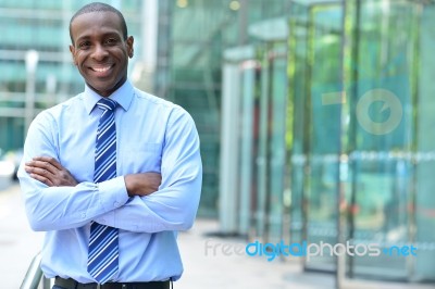 Confident Businessman With Arms Crossed Stock Photo