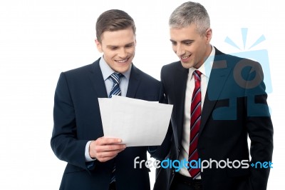 Confident Businessmen Reviewing Records Stock Photo
