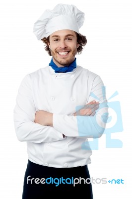 Confident Young Cook Posing In Uniform Stock Photo