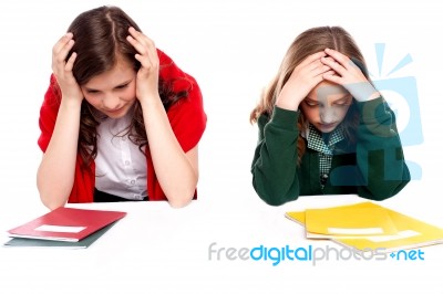 Confused Girls Holding Their Heads Stock Photo