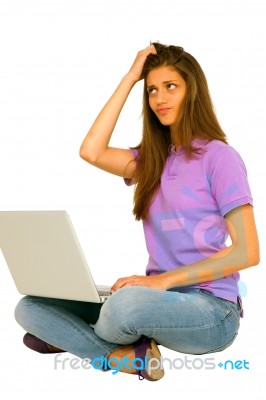 Confused Teenage Girl With Laptop Stock Photo