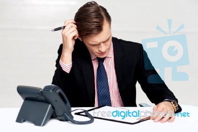 Confused Young Man Itching His Head With Pen Stock Photo