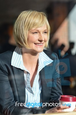 Corporate Lady Sitting In An Open Cafe Stock Photo