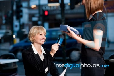 Corporate Lady Swiping Her Card To Pay Stock Photo