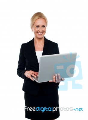 Corporate Woman Holding Laptop Stock Photo