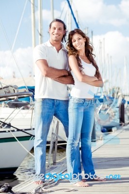 Couple Crossing Arm At Harbor  Stock Photo