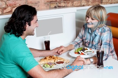 Couple Enjoying Dinner At A Restaurant Stock Photo