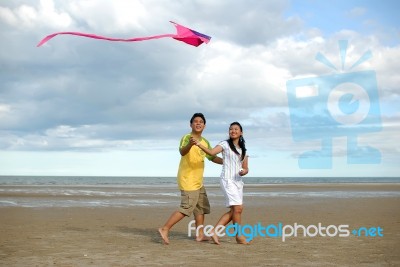 Couple Flying Kite Stock Photo