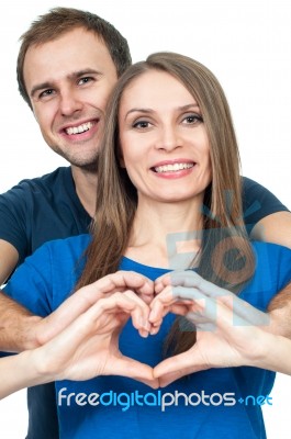 Couple Making Heart Gesture Of Love Stock Photo
