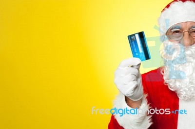 Cropped Image Of Aged Santa Holding Credit Card Stock Photo