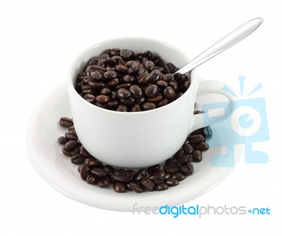 Cup Of Coffee Beans And Spoon On White Background Stock Photo