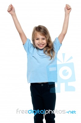 Cute Caucasian Girl Celebrating With Raised Arms Stock Photo