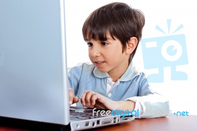 Cute Caucasian Kid Working In Laptop Stock Photo