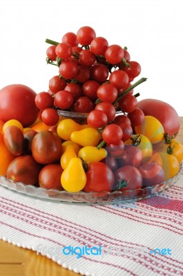 Different Varieties Of Tomatoes In A Glass Vase Stock Photo