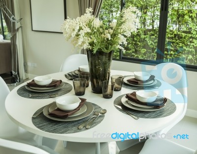 Dining Table And Artificial Flower In Modern Dining Room Stock Photo