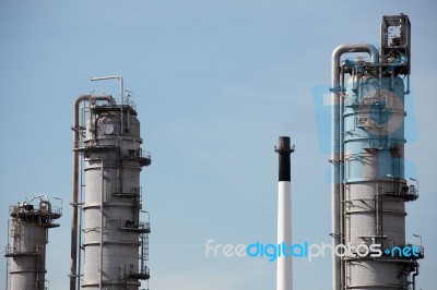 Distillation Towers On Blue Sky Background Stock Photo
