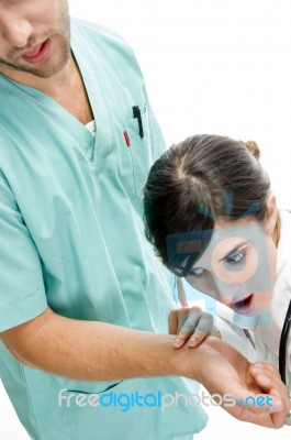 Doctor Checking Pulse Of Surgeon Stock Photo