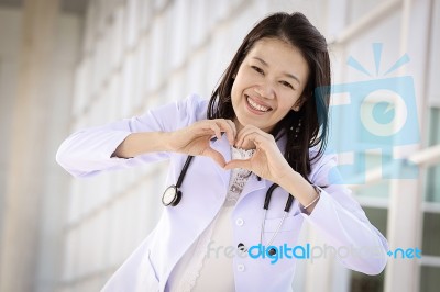 Doctor Make Heart With Her Hand In Hospital Stock Photo
