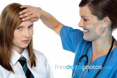 Doctor Placing Her Hand On A Patients Forehead Stock Photo