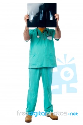 Doctor Reviewing Patient's X-ray Report Stock Photo