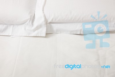Double Bed With White Linens Stock Photo