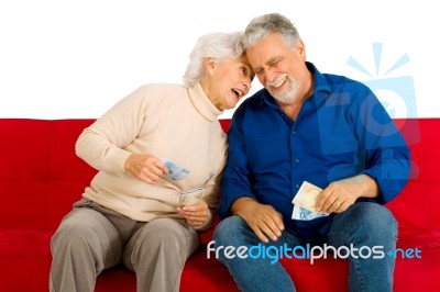 Elderly Couple Holding Money Stock Photo