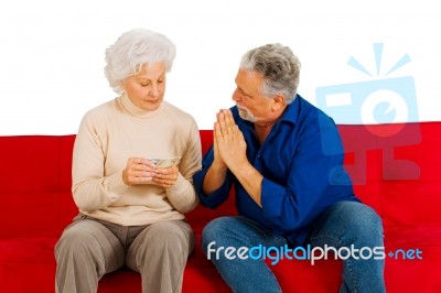 Elderly Couple Sitting In Sofa Stock Photo
