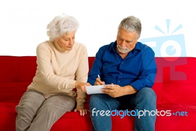Elderly Couple Writing Stock Photo