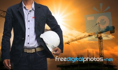Engineer Man Standing With White Safety Helmet Against Beautiful… Stock Photo