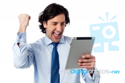 Excited Businessman Holding Touch Pad Stock Photo