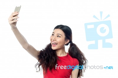 Excited Girl Using Front Camera To Click Self Stock Photo