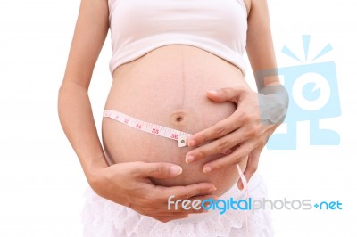 Face Of Pregnancy And Tapeline Abdomen On White Background Stock Photo