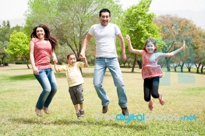 Family Jumping Together Stock Photo