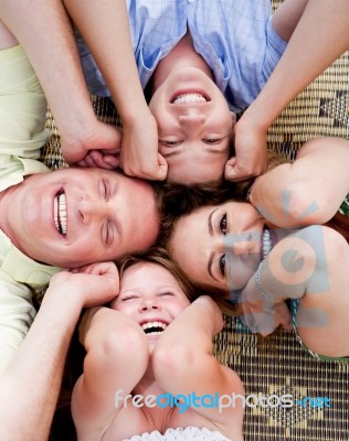 Family Members Lying In A Circle Stock Photo