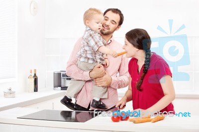 Family Preparing Food In The Kitchen Stock Photo